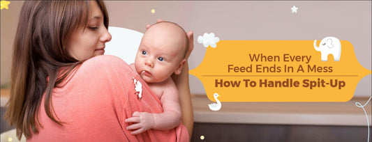 Mother holding baby after feeding, managing spit-up mess.